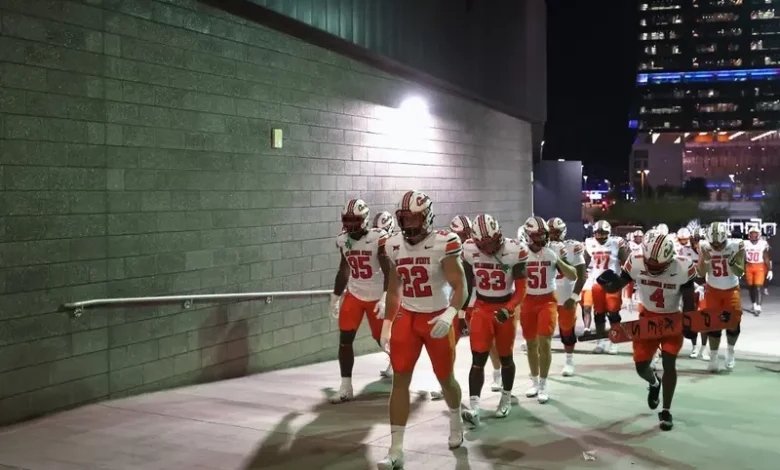 Linebacker Jeff Roberson #22 of the Oklahoma State Cowboys leads teammates onto the field before the NCAAF game against the Arizona State Sun Devils at Mountain America Stadium on September 09, 2023 in Tempe, Arizona
