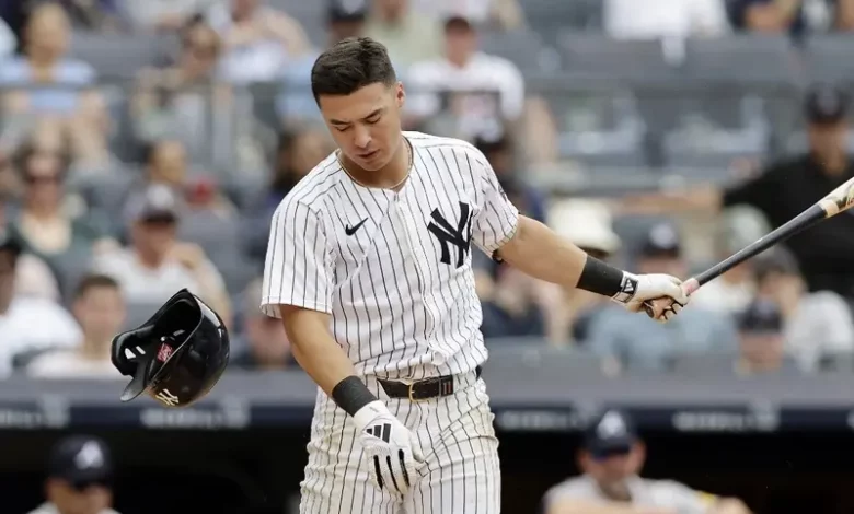 Anthony Volpe #11 of the New York Yankees loses his helmet after a swing during the eighth inning against the Atlanta Braves at Yankee Stadium on June 23, 2024 in New York City.