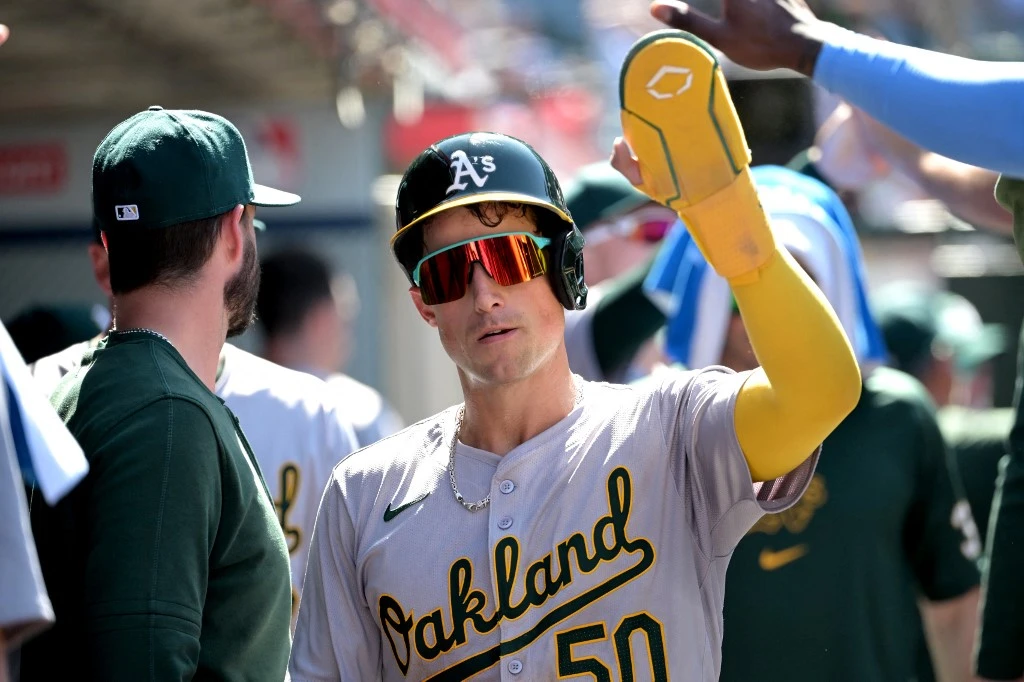 Armando Alvarez #50 of the Oakland Athletics is greeted in the dugout after scoring a run in the ninth inning against the Los Angeles Angels at Angel Stadium of Anaheim on June 26, 2024 in Anaheim, California.
