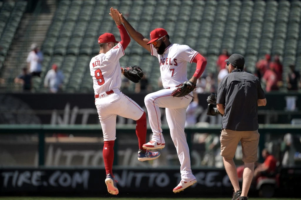 Zach Neto #9 of the Los Angeles Angels and Jo Adell #7 celebrate after the final out of the ninth inning against the Oakland Athletics at Angel Stadium of Anaheim on June 26, 2024 in Anaheim, California.