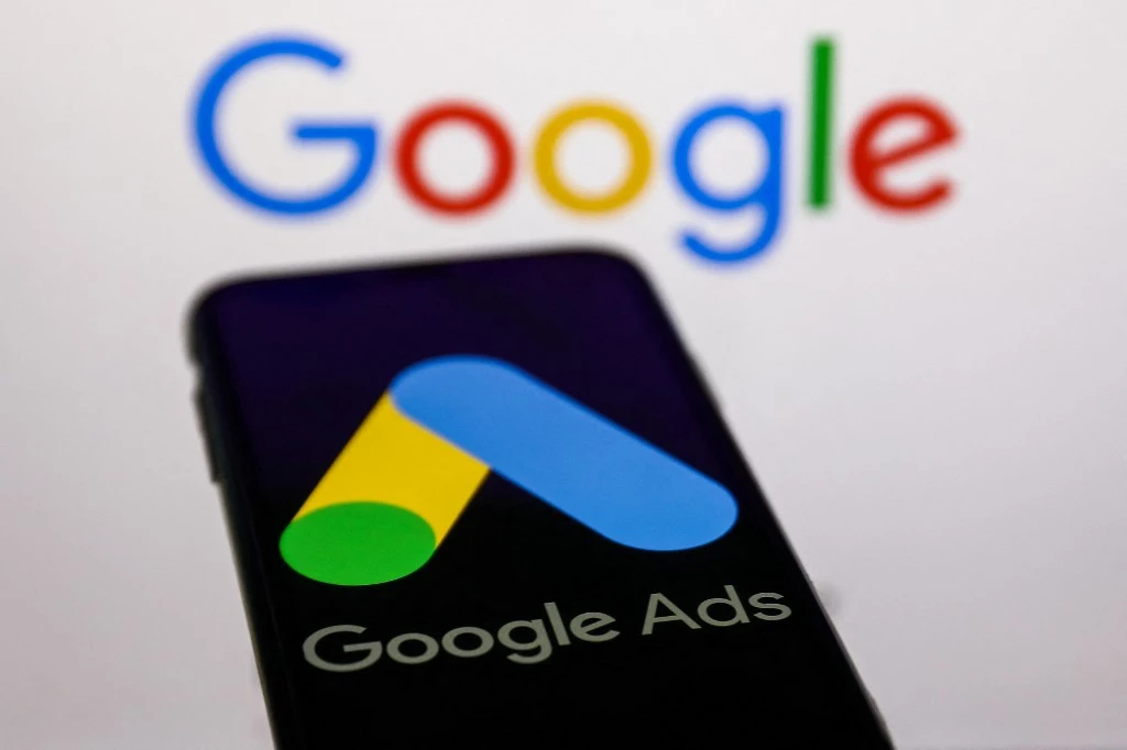Google Ads logo displayed on a phone screen and Google logo displayed on a screen in the background are seen in this illustration photo taken in Krakow, Poland on May 26, 2022