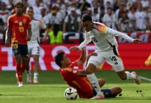 Spain's midfielder #16 Rodri fights for the ball with Germany's midfielder #10 Jamal Musiala during the UEFA Euro 2024 quarter-final football match between Spain and Germany at the Stuttgart Arena in Stuttgart on July 5, 2024.
